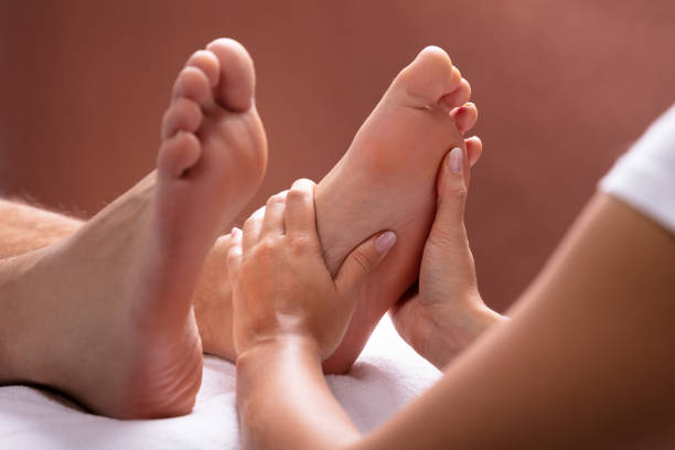 Close-up Of Therapist Hand Giving Foot Massage To Man istockphoto 1075627838 612x612 1